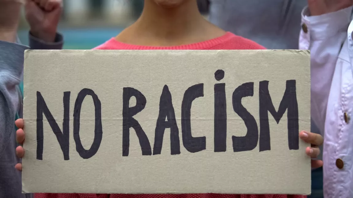 A sign that reads 'no racism'.