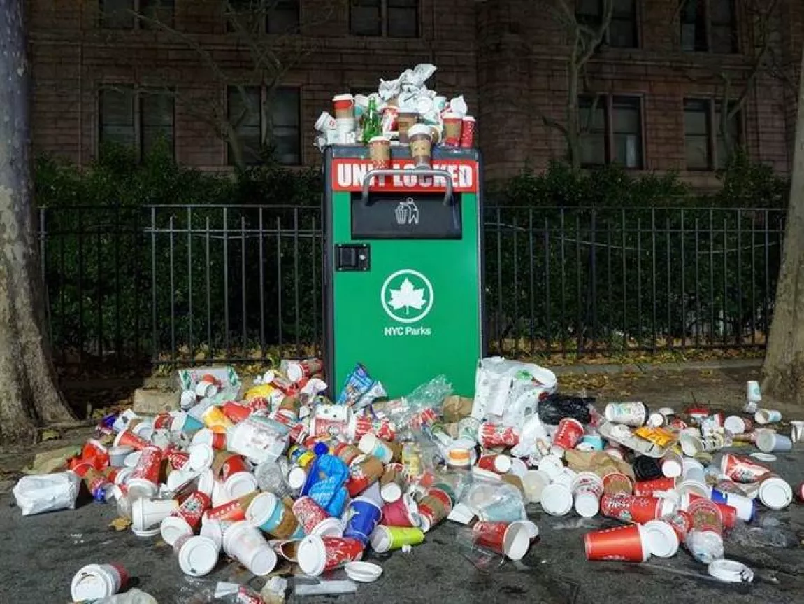 A bin overflowing with litter.