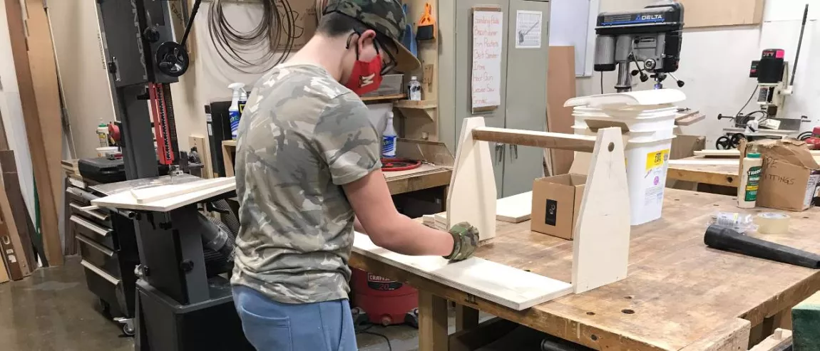Young people doing woodworking